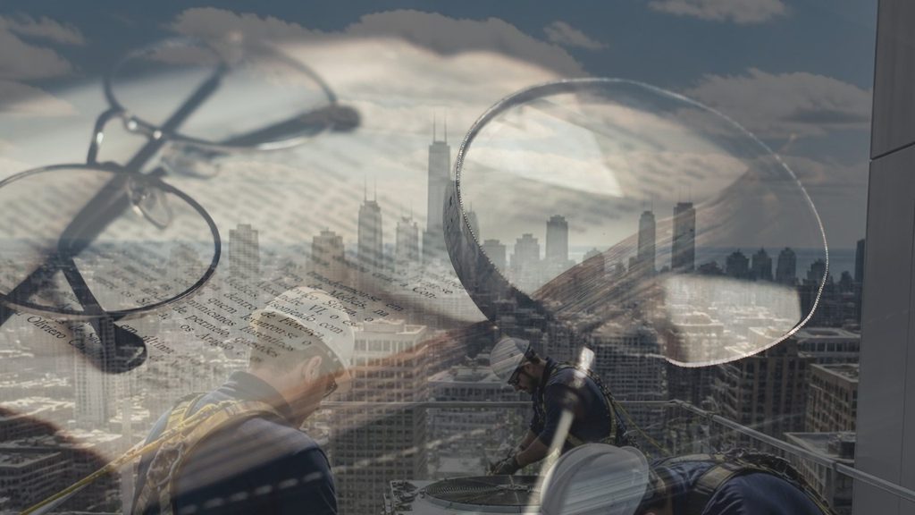 Glasses on paperwork over the Chicago skyline